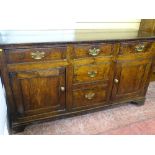 AN ANTIQUE OAK & LATER DRESSER BASE of three frieze drawers over two blind drawers with twin