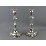 A FINE PAIR OF CIRCULAR SILVER CANDLESTICKS having scrolled bases with shaped and scrolled