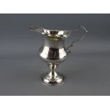 A GEORGE IV SILVER HELMET SHAPED PEDESTAL CREAM JUG with beaded foot and rim decoration, London