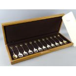 A CASED SET OF TWELVE RSPB COLLECTOR'S SILVER SPOONS, hallmarked London 1975, each set with gold