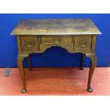 AN 18th CENTURY OAK THREE DRAWER LOWBOY on cabriole supports and pad feet, 69 cms high, 83 cms wide,