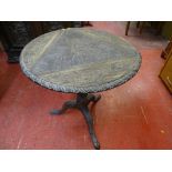 AN ANTIQUE CARVED OAK TRIPOD TABLE (ex triple flap twist top now fixed), 74.5 cms high, 69 cms