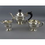 A THREE PIECE BACHELOR'S SILVER TEA SERVICE, pedestal form with scroll handles, Chester 1901, 12.4