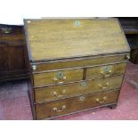 A GEORGIAN OAK FALL FRONT BUREAU with interior sliding well and mixed drawer and pigeonhole