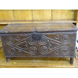 AN ANTIQUE OAK SIX PLANK CHEST with carved front detail, 42 cms high, 80 cms wide, 32 cms deep,