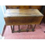 A CIRCA 1830 PERIOD OAK TWIN FLAP GATE LEG DINING TABLE on turned and block supports, 74 cms high,