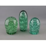 THREE VICTORIAN GREEN GLASS DUMP PAPERWEIGHTS, all in stand-up form with bubble inclusions, 15 cms