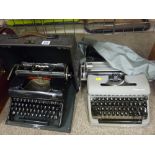 Vintage Olympia Progress portable typewriter in carry case and a slightly more modern Olympia