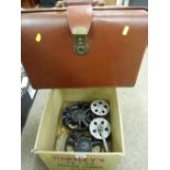 Vintage leather briefcase and a boxed quantity of film reels