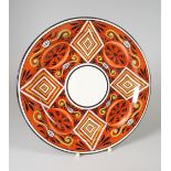 A RARE SWANSEA POTTERY PLATE enamelled with geometric design to an iron red ground impressed mark