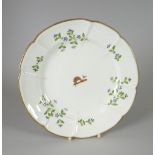 A SWANSEA PORCELAIN DISH of lobed form and decorated with cornflower sprigs and centred armorial