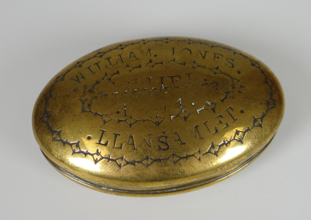 A VICTORIAN OVAL BRASS SNUFF BOX having a hinging lid inscribed in block capitals 'William Jones,