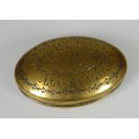 A VICTORIAN OVAL BRASS SNUFF BOX having a hinging lid inscribed in block capitals 'William Jones,
