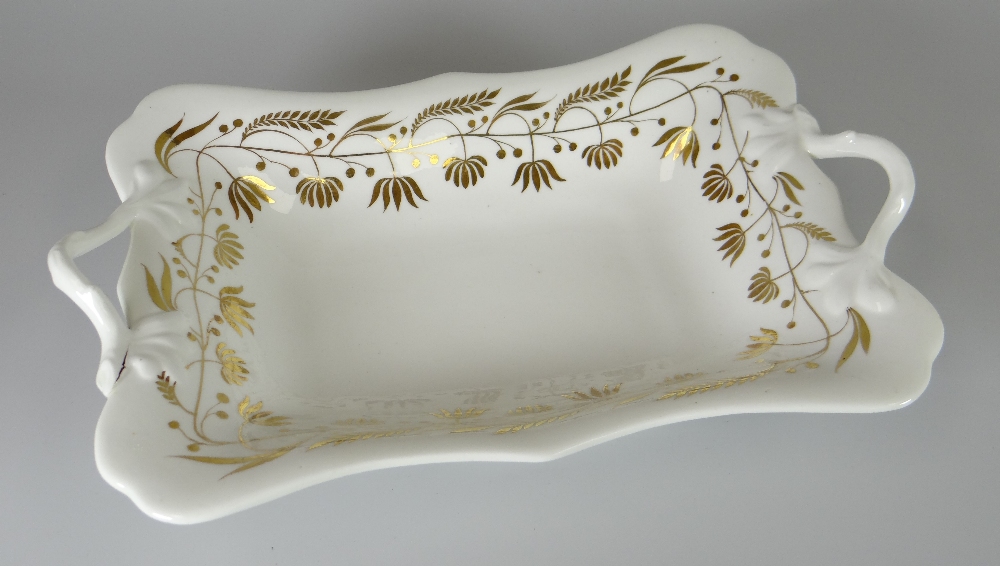 A SWANSEA PORCELAIN TWIG-HANDLED CENTRE DISH of shaped rectangular form, decorated in the gilded