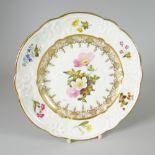 A SWANSEA PORCELAIN DESSERT PLATE with lobed rim and having a moulded border with C-scrolls,