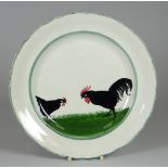 A LLANELLY POTTERY COCK & HEN DECORATED PLATE the birds pecking on grass and within green continuous