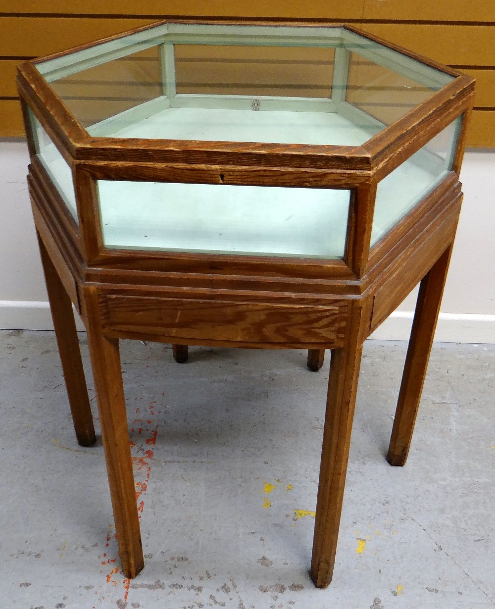 A BRYNMAWR PITCH-PINE SPECIMEN TABLE OF HEXAGONAL FORM with raised top having glass panes to each