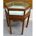 A BRYNMAWR PITCH-PINE SPECIMEN TABLE OF HEXAGONAL FORM with raised top having glass panes to each