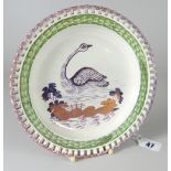 A DILLWYN & CO SWANSEA POTTERY RIBBON PLATE having a basket-weave border painted green and decorated