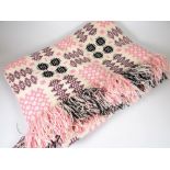 TRADITIONAL WELSH WOOL BLANKET of cream ground and having pink, purple and black geometric patterns,
