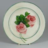 A LLANELLY POTTERY TEA-ROSE PLATE in typical green border by Shufflebotham, 22cms diam Condition