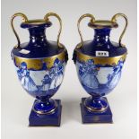 A pair of Continental twin-handled pottery pedestal vases decorated with Dutch figures Condition