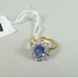 18ct yellow gold sapphire and diamond ring, the oval sapphire surrounded by ten diamonds, 3.9