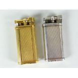Two Dunhill gas cigarette lighters with white metal and yellow metal engine turned example Condition