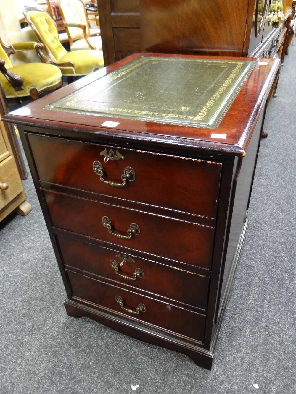 A reproduction two-drawer mahogany effect filing cabinet with tooled leather insert top Condition