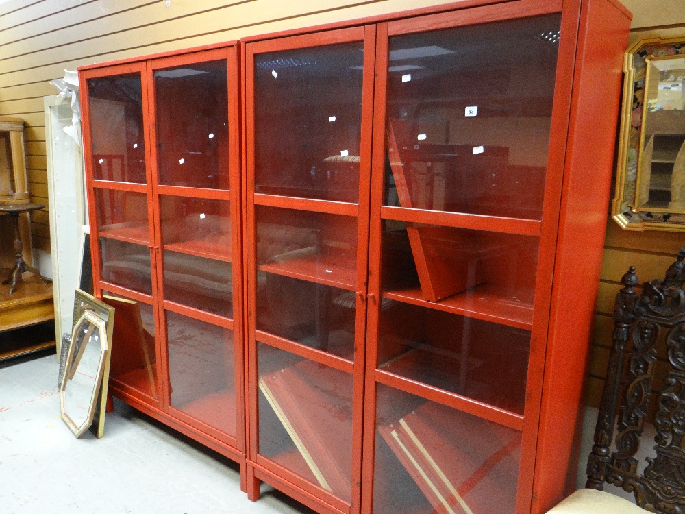 A pair of red IKEA display cabinets, a parcel of mirrors and two further narrow display cabinets