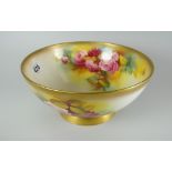 A Royal Worcester porcelain footed bowl painted with pink roses and foliage to interior and