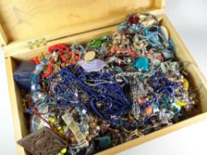 A wooden box containing a large parcel of mixed costume jewellery, beads ETC Condition reports