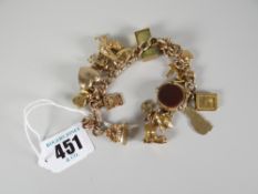 9ct gold flat curb link bracelet with assorted charms to include revolving blood stone fob, one