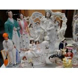 A collection of Staffordshire figures including three bough groups, a wedding couple ETC Condition