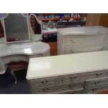 A vintage cream French-style six-piece bedroom suite comprising kidney shaped dressing table,