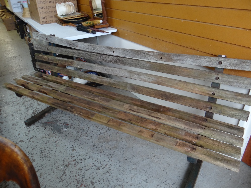 A slatted garden bench on metal supports Condition reports provided on request by email for this