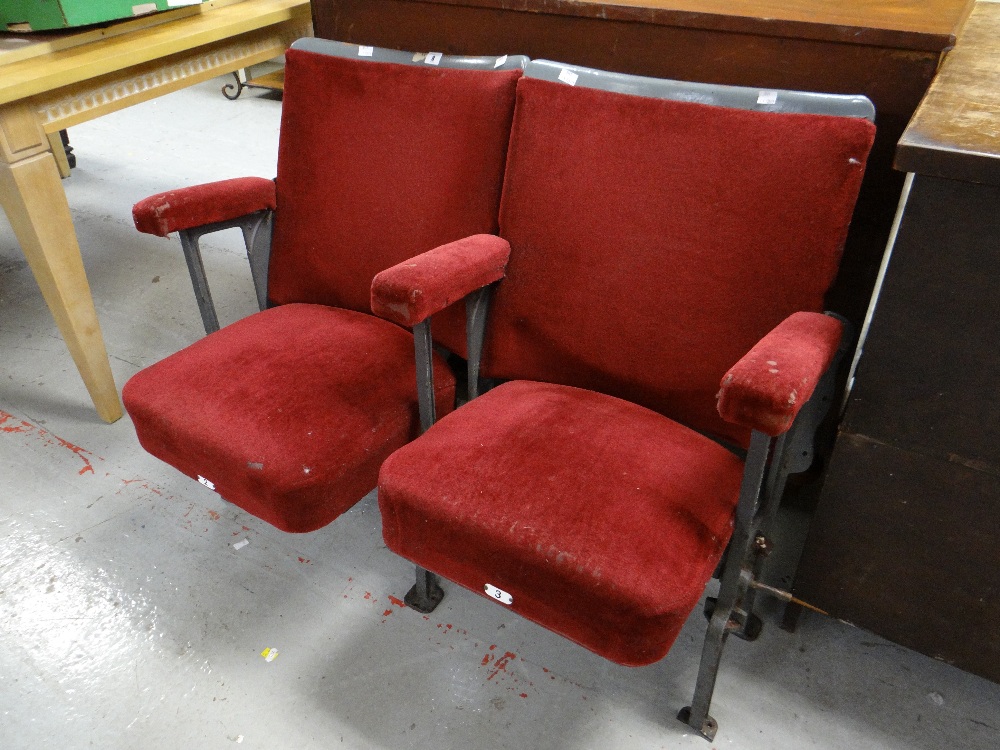 A pair of vintage numbered red upholstered folding cinema-seats removed from a South Wales cinema