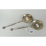 Pair of silver pierced possibly bon bon or nut spoons, having flat circular heads and dolphin