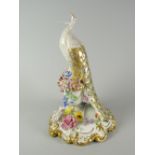 A Royal Crown Derby porcelain peacock model perched on an urn of flowers, decorated in gilding and