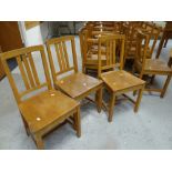 A set of twenty-six Brynmawr oak chairs of simple form with three vertical rail backs, some