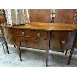 An inlaid mahogany antique breakfront sideboard having a pair of flanking curved cupboards, centre
