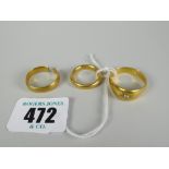 Three 22ct yellow gold rings comprising two band rings (one damaged) and another with small