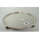 Solid silver salver raised on four scroll-type feet, London hallmarked, maker's J R C A Ltd, 21 troy