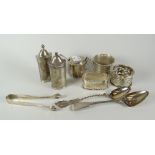 Group of assorted silver items to include napkin rings, various condiments, sugar tongs ETC