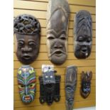 Collection of seven carved grotesque native-arts tribal masks, some with painted designs Condition
