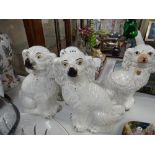 Four various seated Staffordshire pottery spaniels Condition reports provided on request by email
