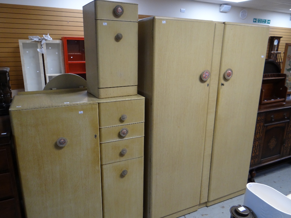 A vintage four-piece painted bedroom set comprising double wardrobe, tallboy, an oval mirrored
