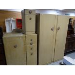 A vintage four-piece painted bedroom set comprising double wardrobe, tallboy, an oval mirrored