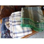 A pale green, yellow & black geometric patterned Welsh blanket, two check woollen blankets & a