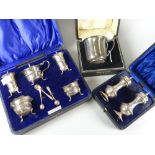 Three cased silver items comprising plain-body mug with decorative handle, 2.3ozs, a pair of salt
